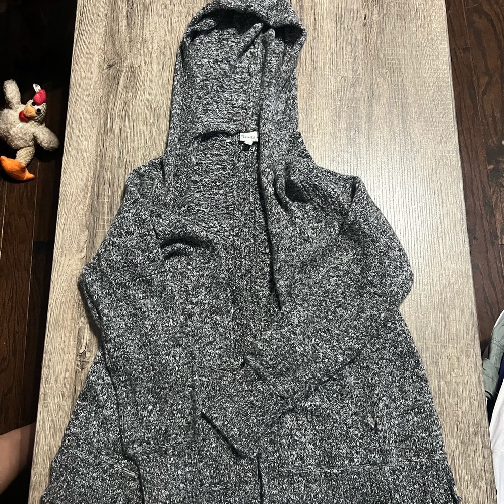 A grey, black, and white knitted and hooded cardigan from Mudd